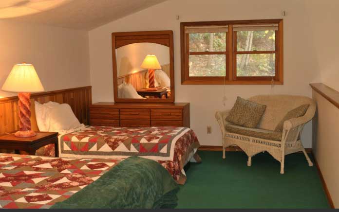 Bedroom with Two Beds and a Chair